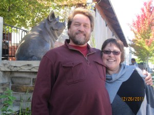 Adam Schultz and Lori Acott. Behind Sandy Scott's bronze pig.